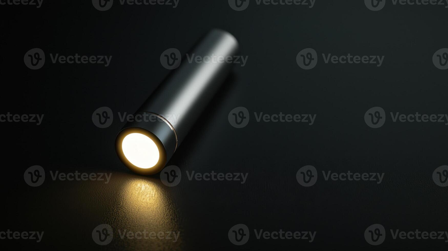 A flashlight is shown on a black surface photo