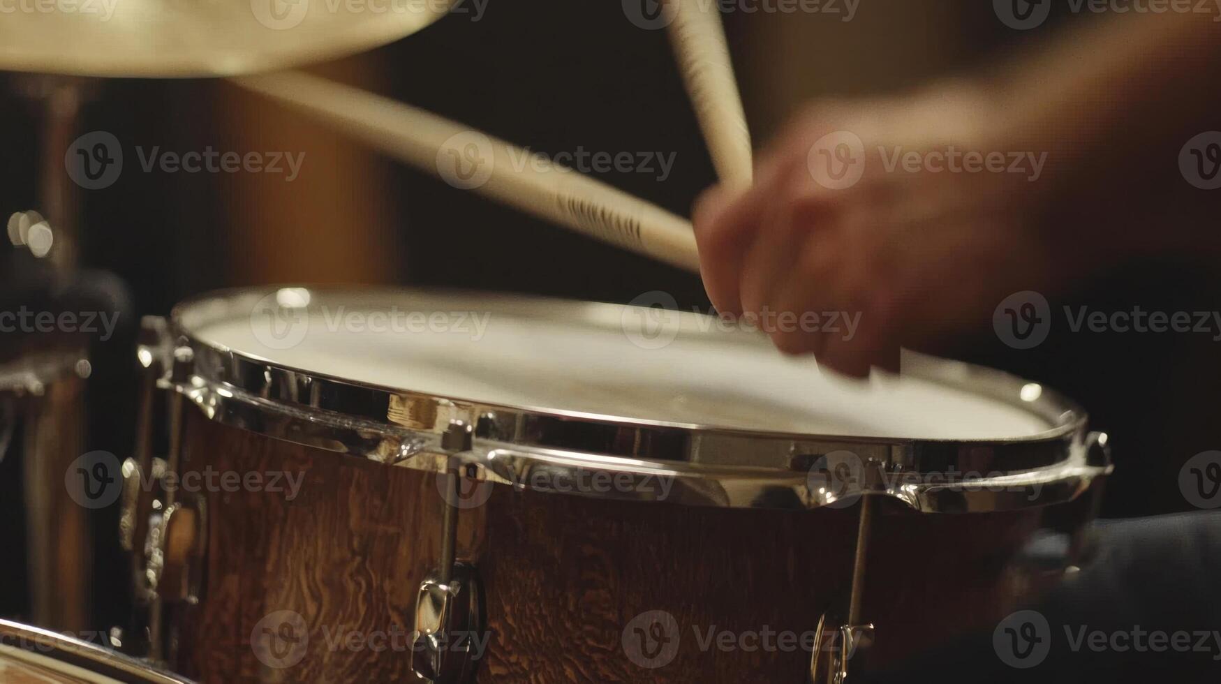 A close up of a drummer playing a drum photo