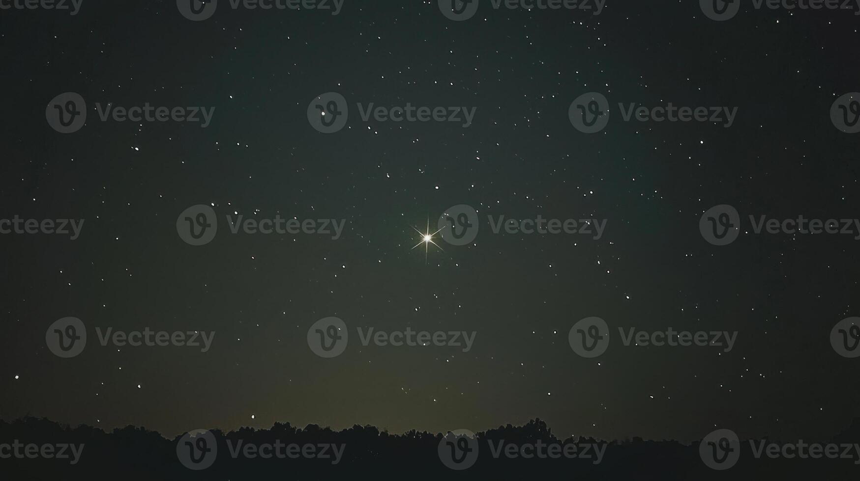 A star shines brightly in the night sky photo