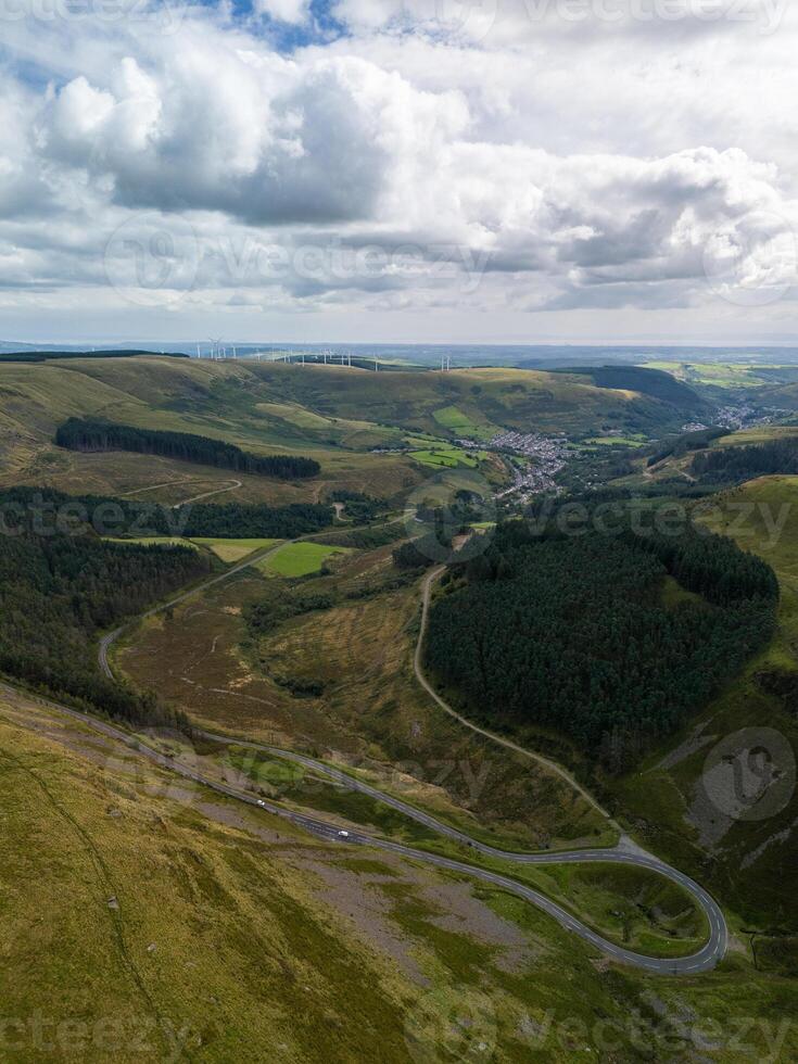 Winding road leading through green hills in wales photo