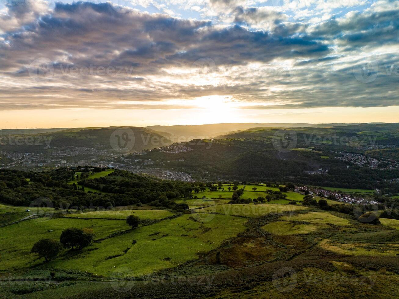 Sunset casting shadows over the green hills of wales photo