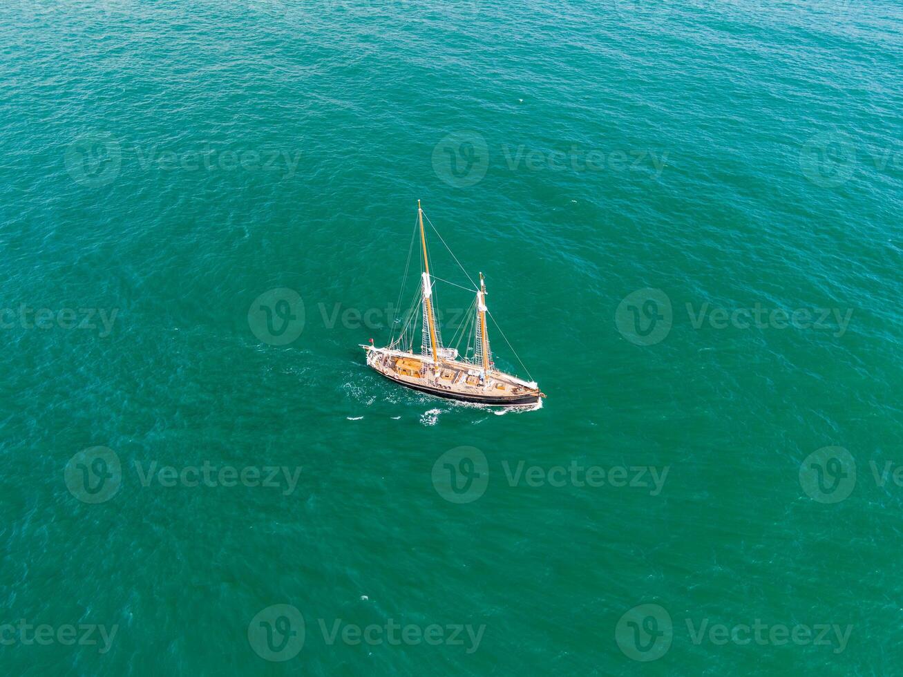 Classic sailing yacht navigating the turquoise waters of newquay photo