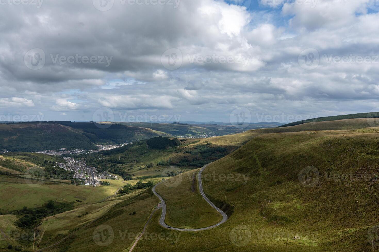 Winding mountain road leading to small town in wales photo