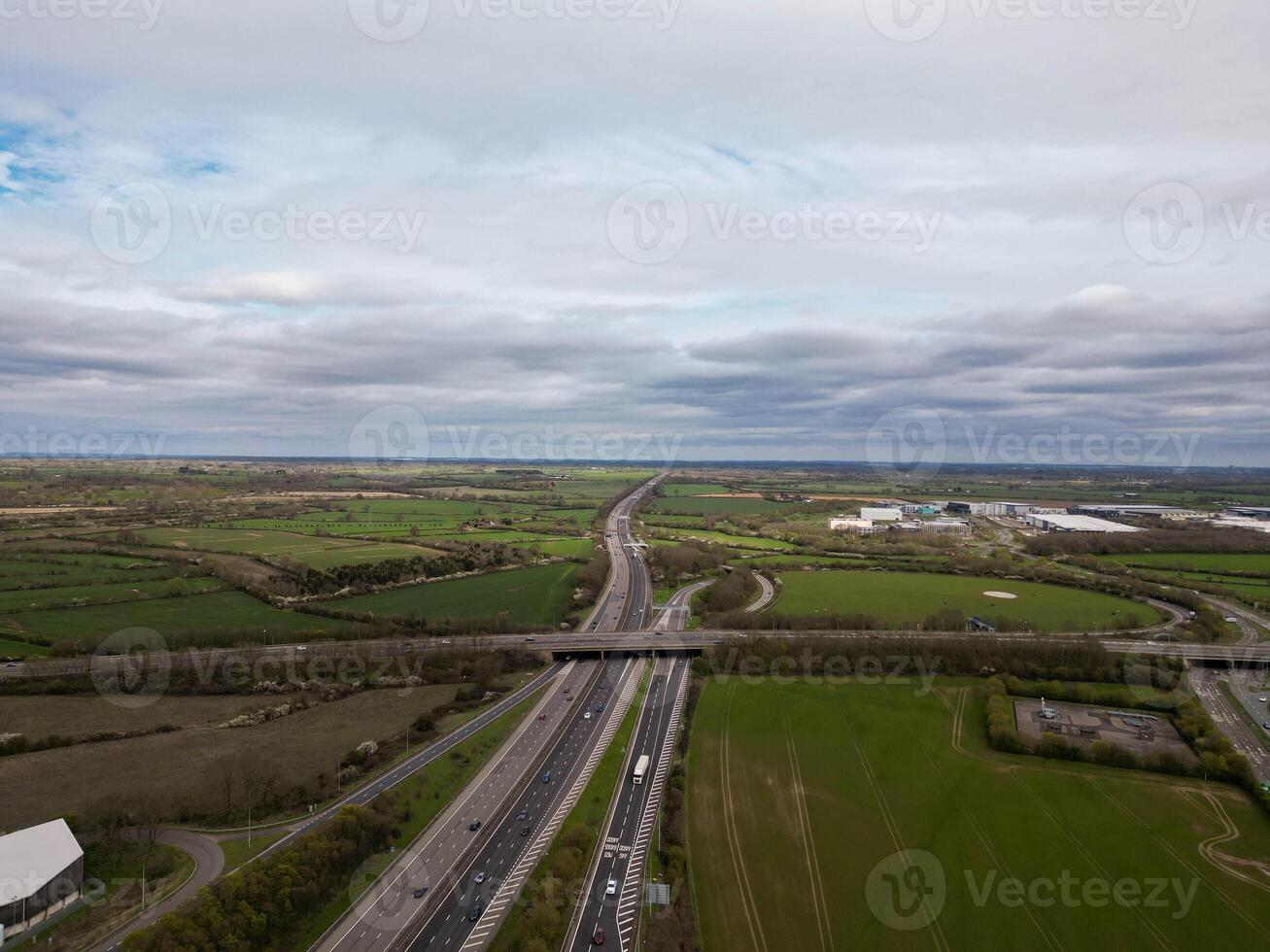 Highway crossing the countryside under a cloudy sky photo