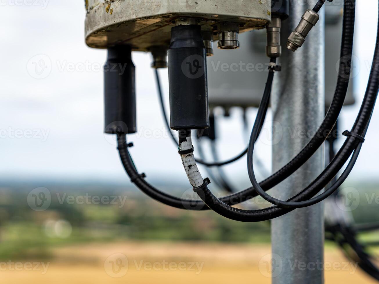 Telecommunication tower antenna is transmitting signal over countryside photo
