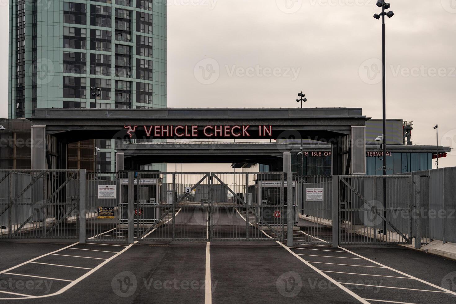 Vehicle check in area at liverpool ferry terminal showing closed barriers and signage photo