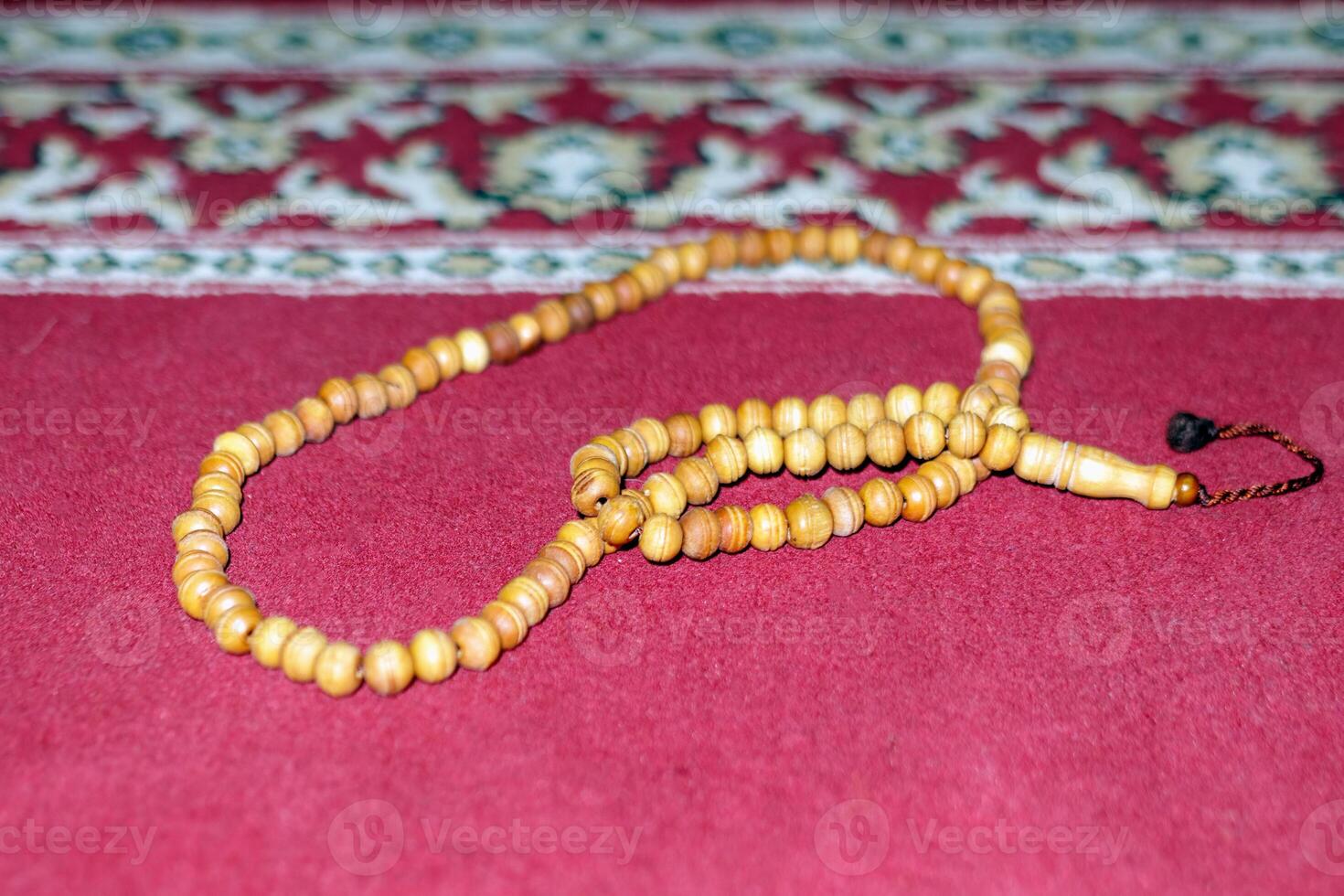 Wooden Prayer Beads on Red Carpet in Spiritual Setting photo