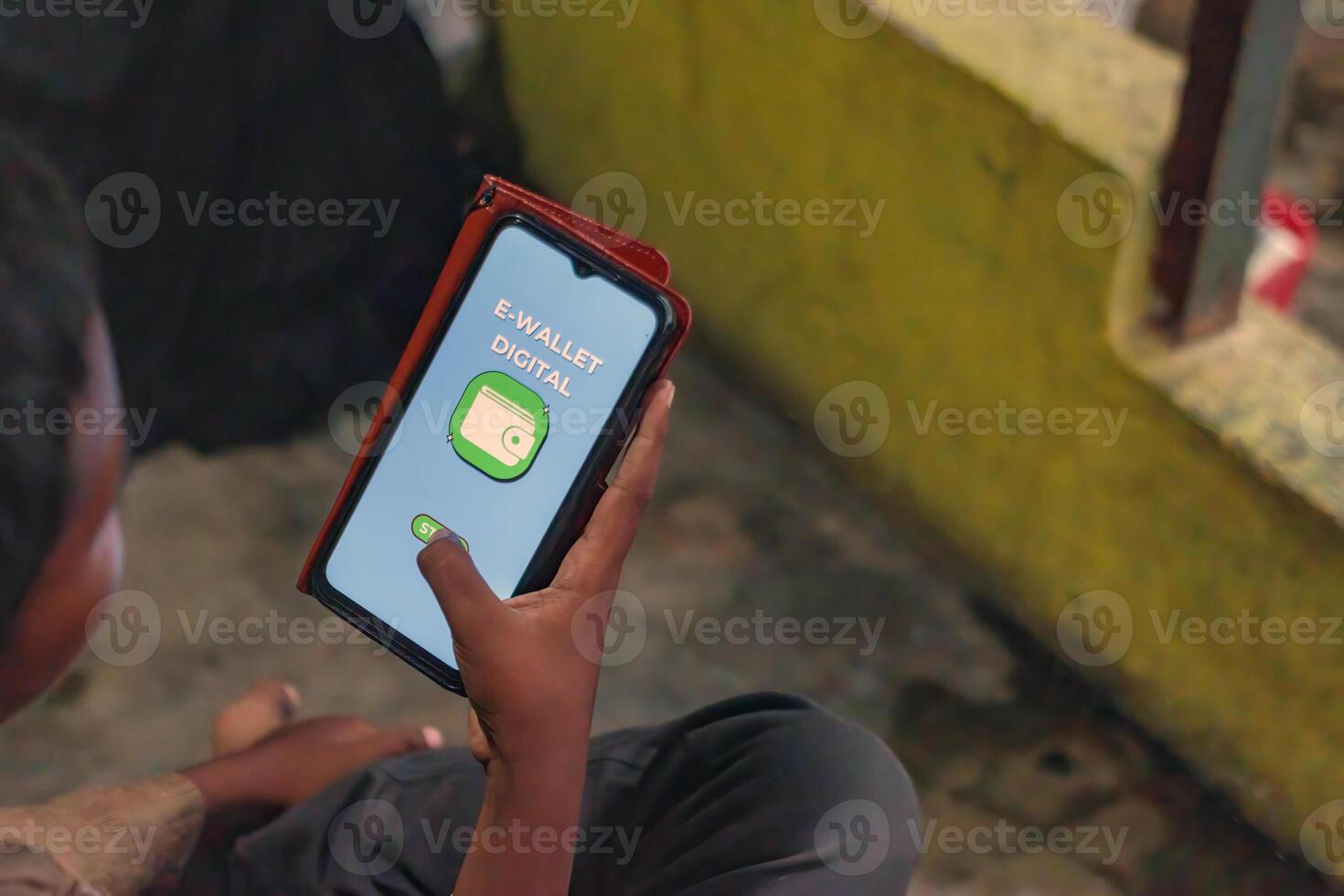 Young Boy Using Digital Wallet App on Smartphone for Online Payment photo