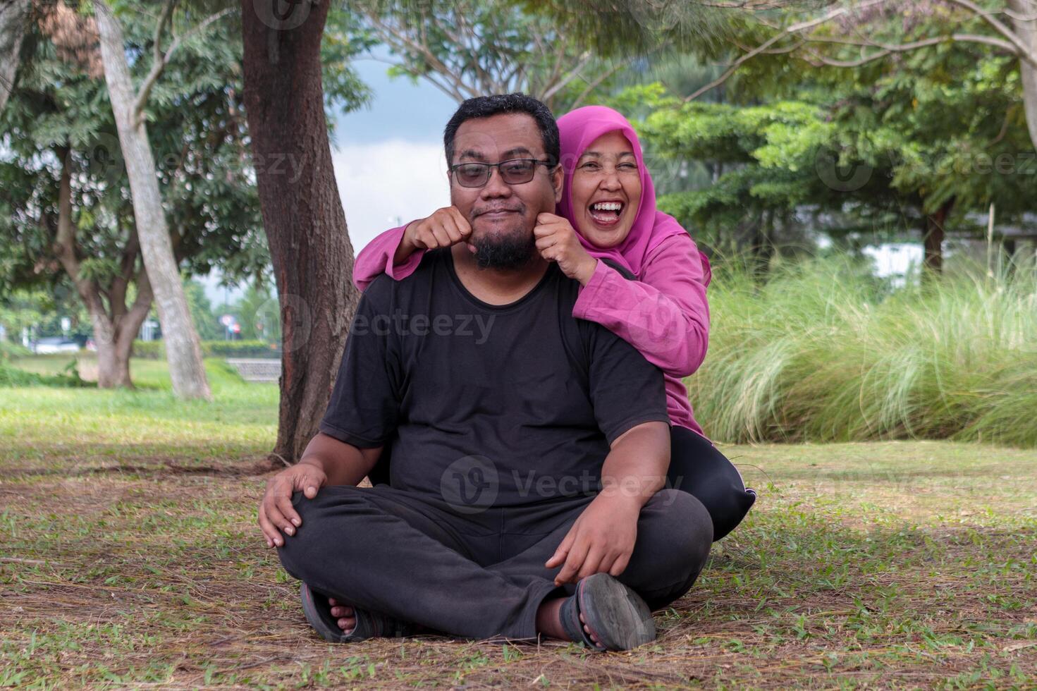 Happy Muslim Couple Having Fun in the Park photo