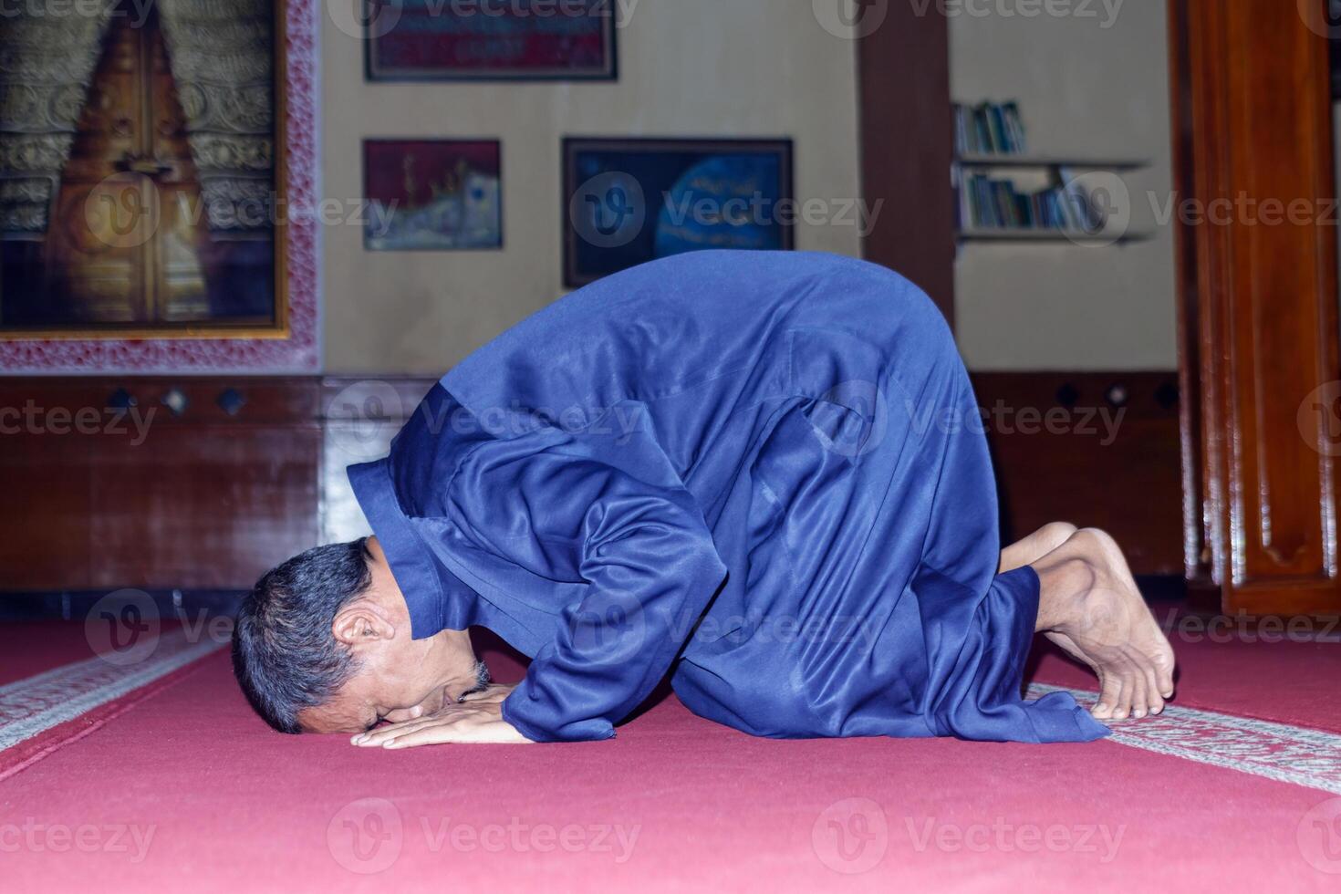 Muslim Man Praying Sujud in Mosque Eid Mubarak photo
