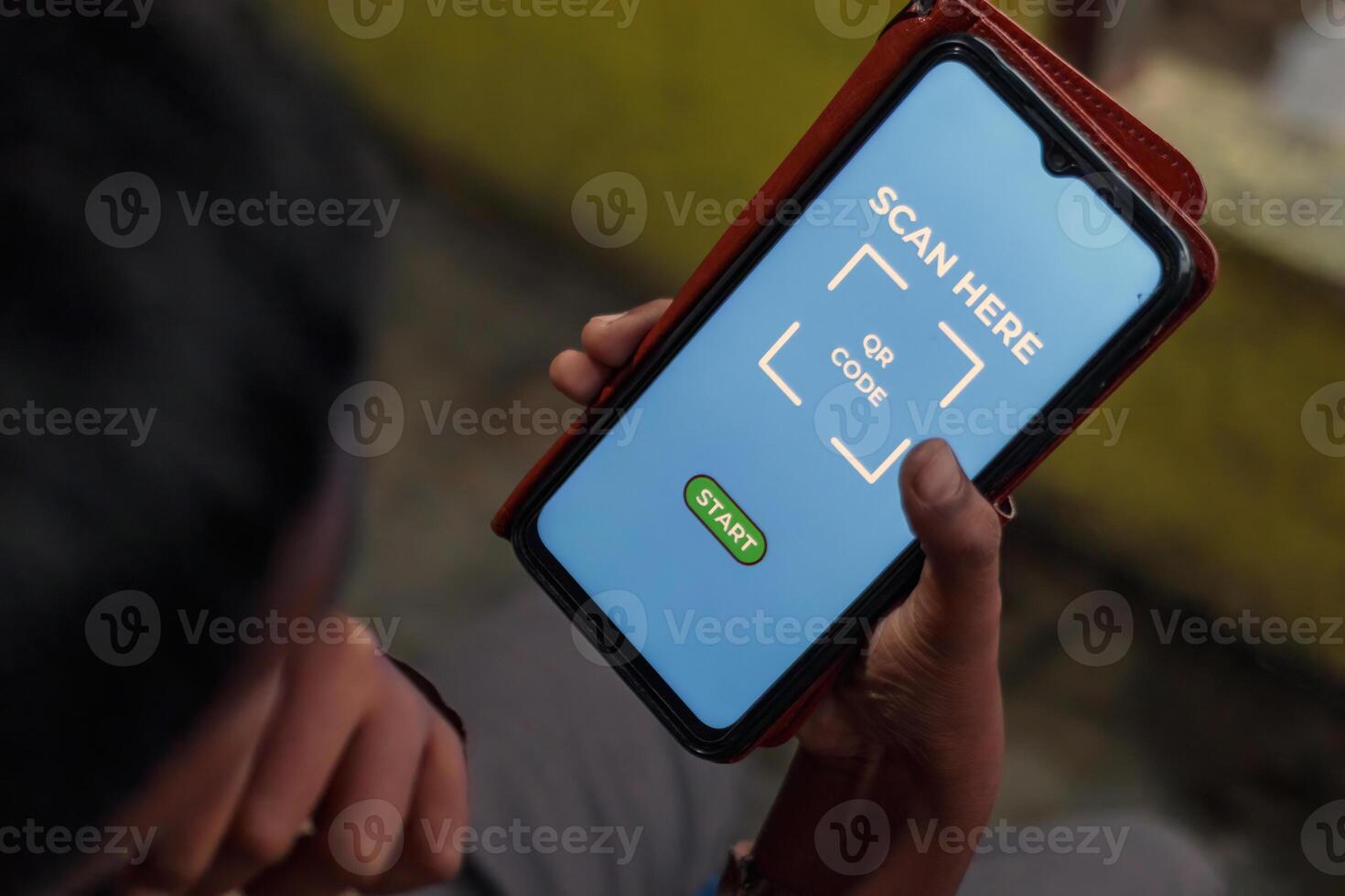Man Holding Smartphone Scanning QR Code with Mobile App photo