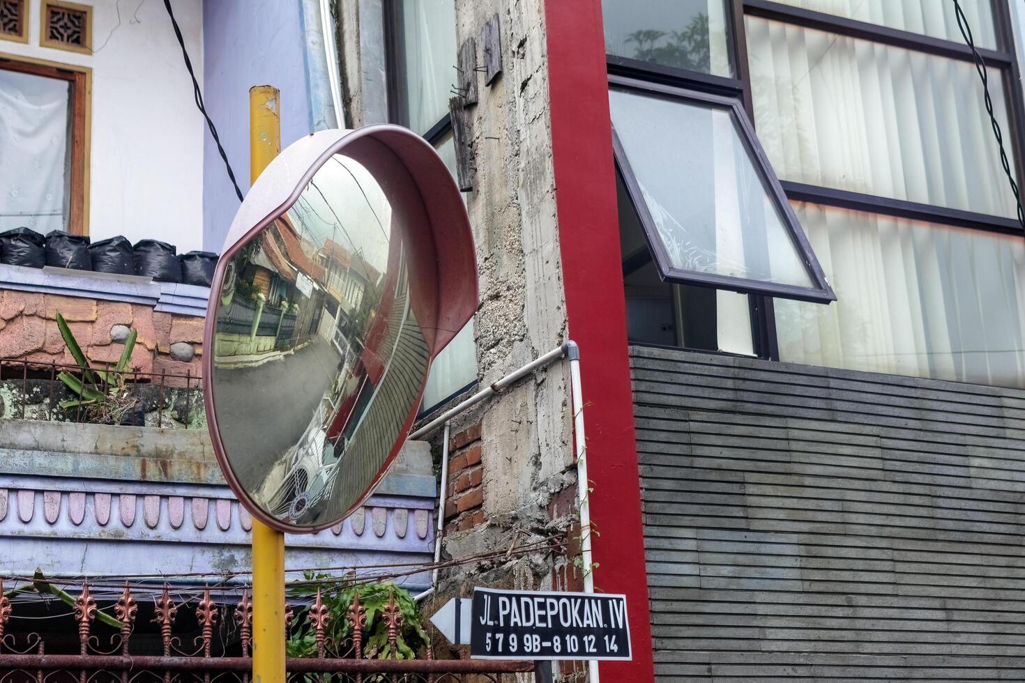 Urban Traffic Mirror Reflection in Narrow Street, Bandung Indonesia, 06 March 2025 photo