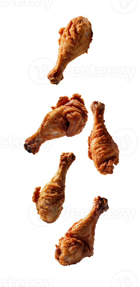 Five crispy fried chicken drumsticks falling on transparent background png