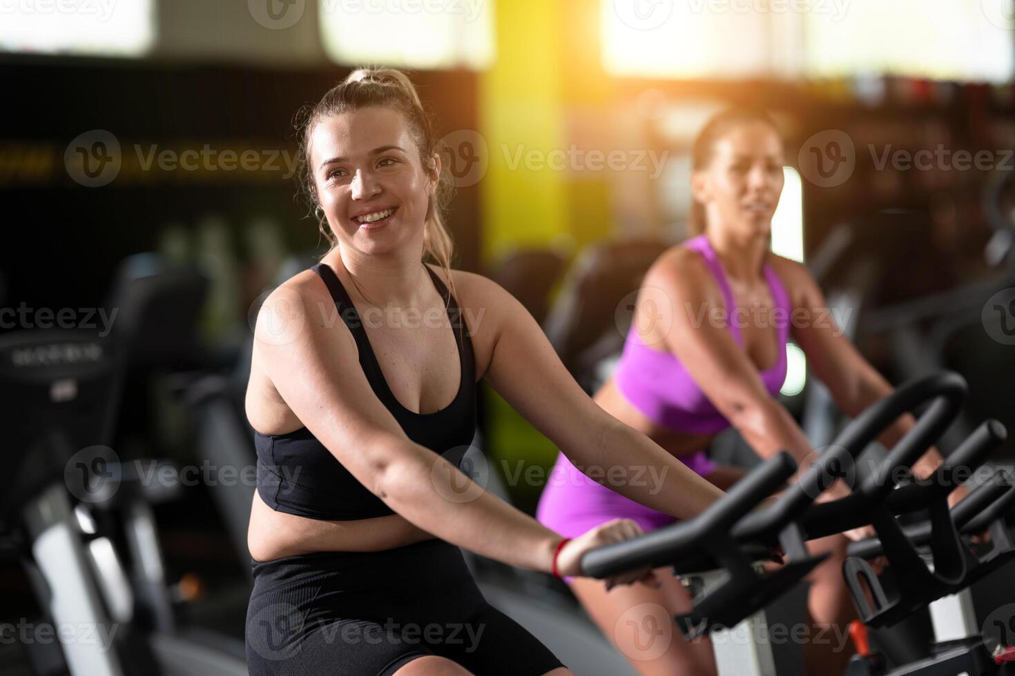 Two fitness women working together on a conditioning workout in the gym, supporting each other with strength, focus, and determination. photo