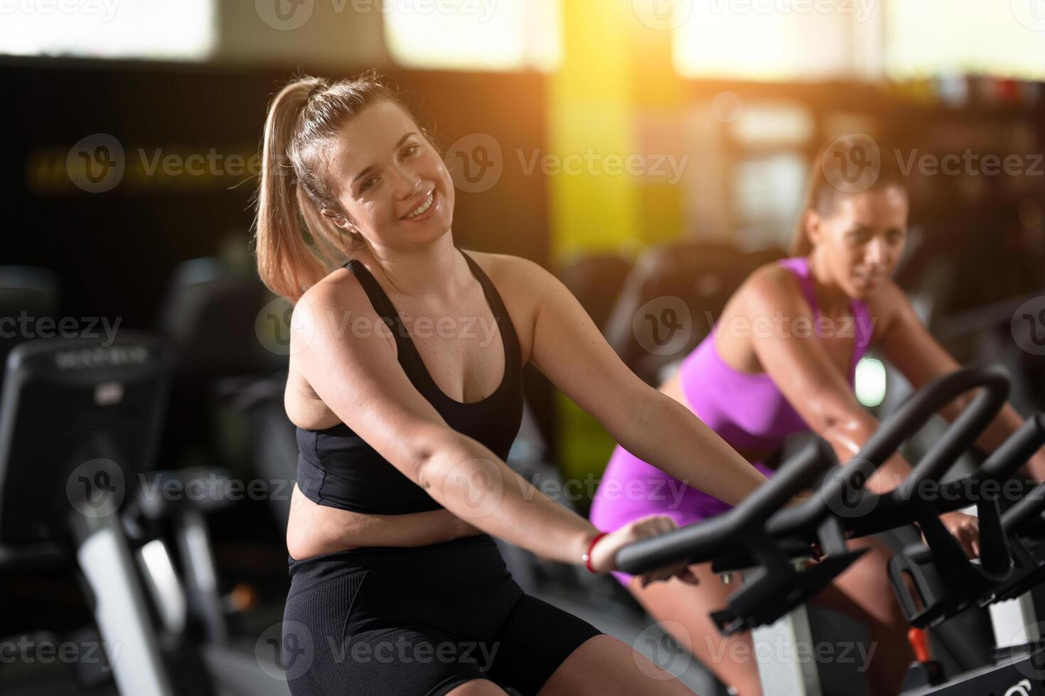 Two fitness women working together on a conditioning workout in the gym, supporting each other with strength, focus, and determination. photo
