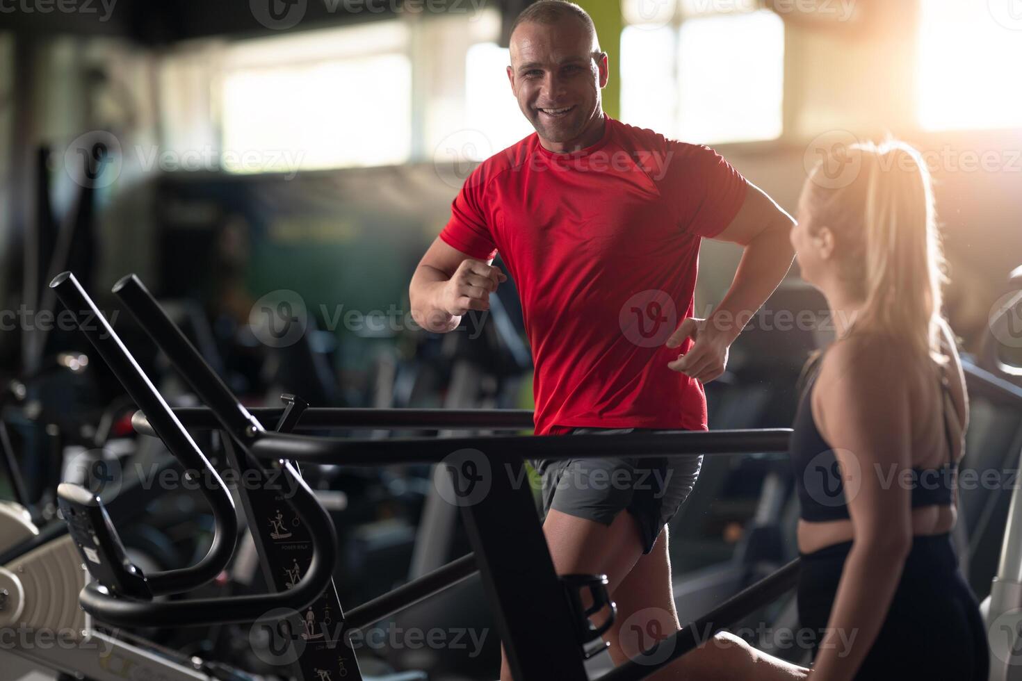 A couple working together in the gym, performing a conditioning workout side by side, supporting each other with strength, motivation, and teamwork. photo
