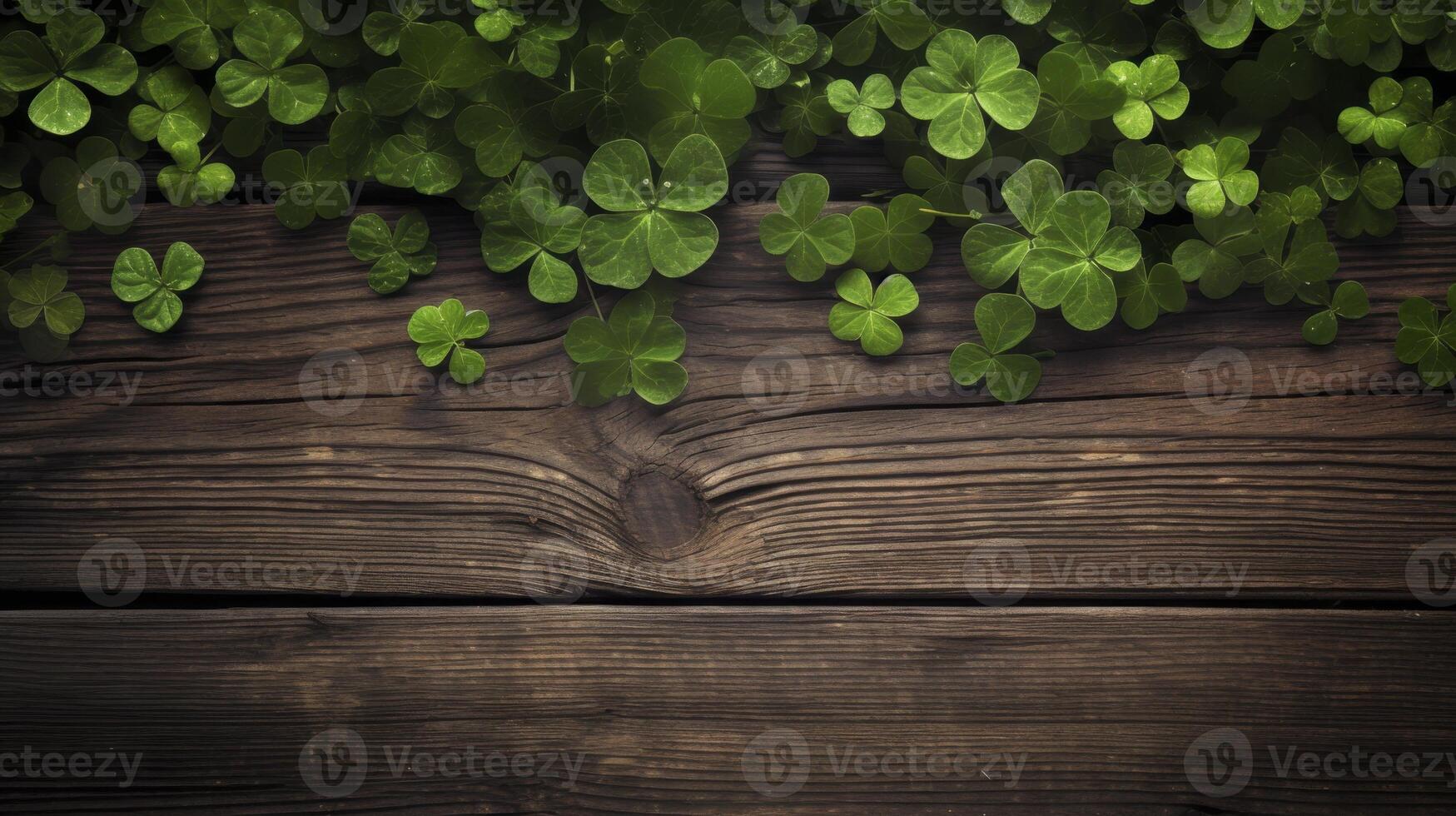 A wooden surface with green clovers on it photo