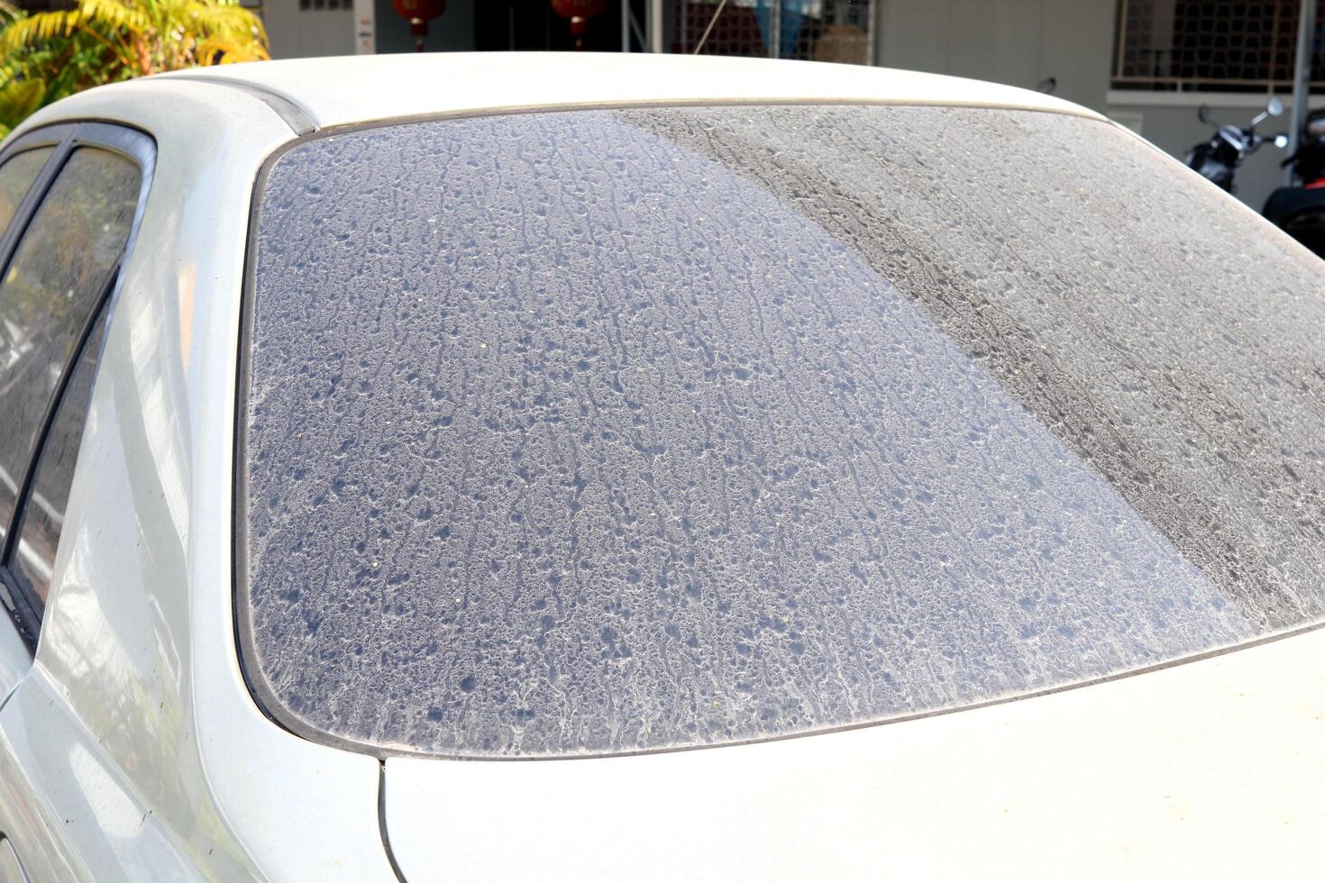 Dust on back windscreen of old retro style car and some spot of dry raindrops. photo
