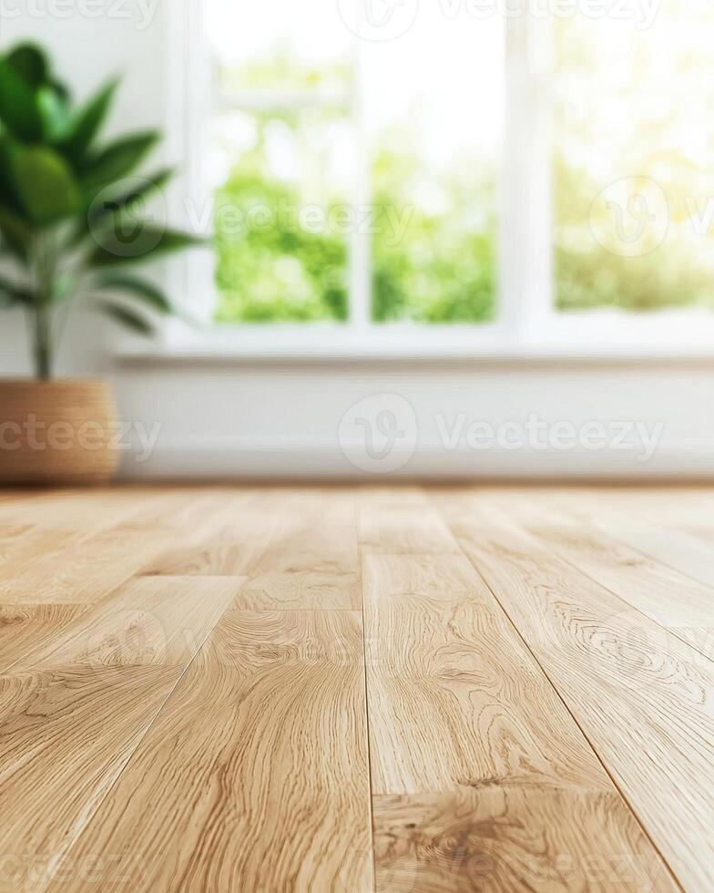 A bright, airy room with wooden flooring and a potted plant, featuring large windows that allow natural light to flood in. photo