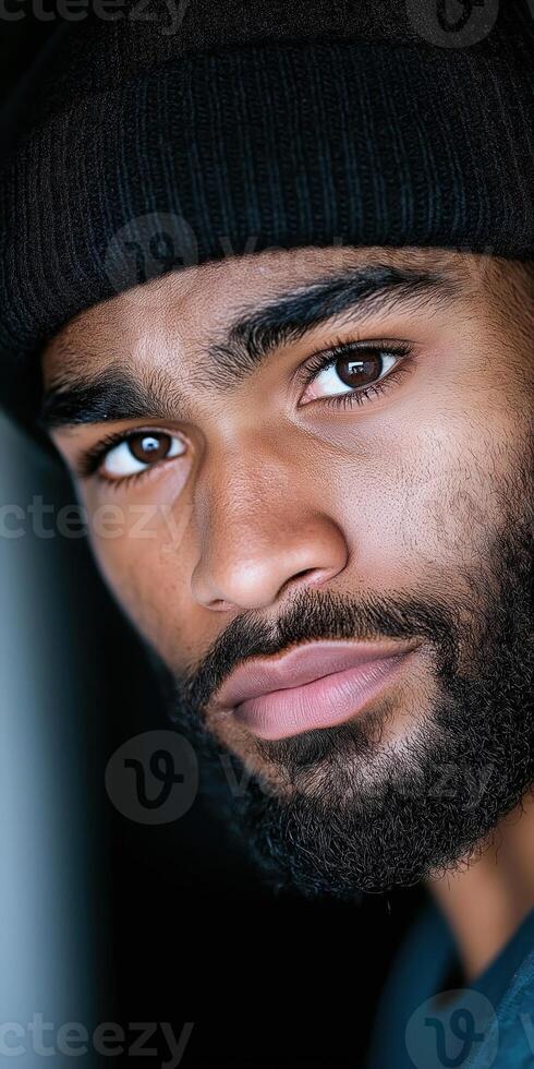 Close Up Portrait of a Bearded Man in a Black Beanie with Intense Expression photo