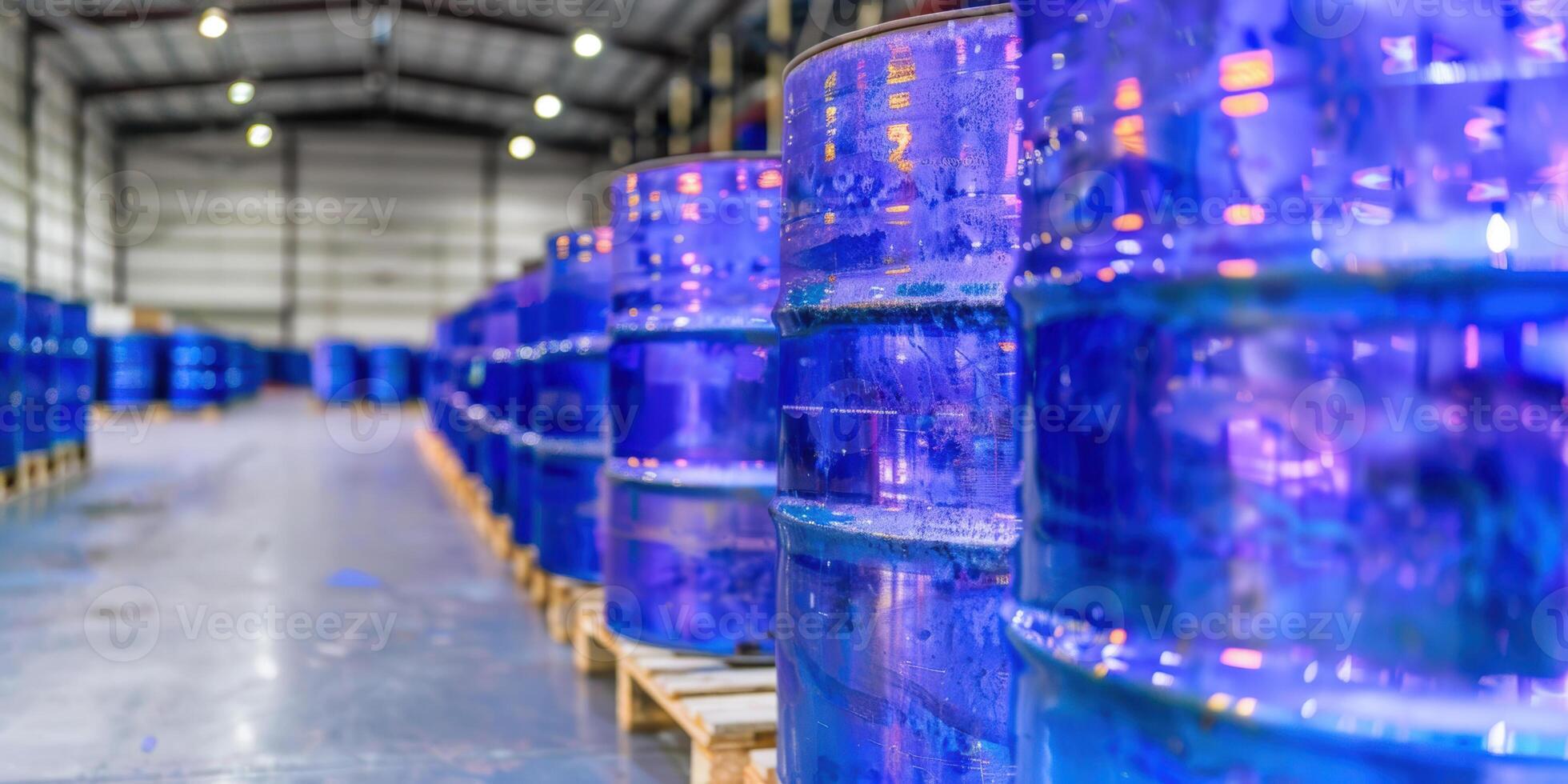Industrial warehouse with blue oil barrels arranged in rows on wooden pallets photo