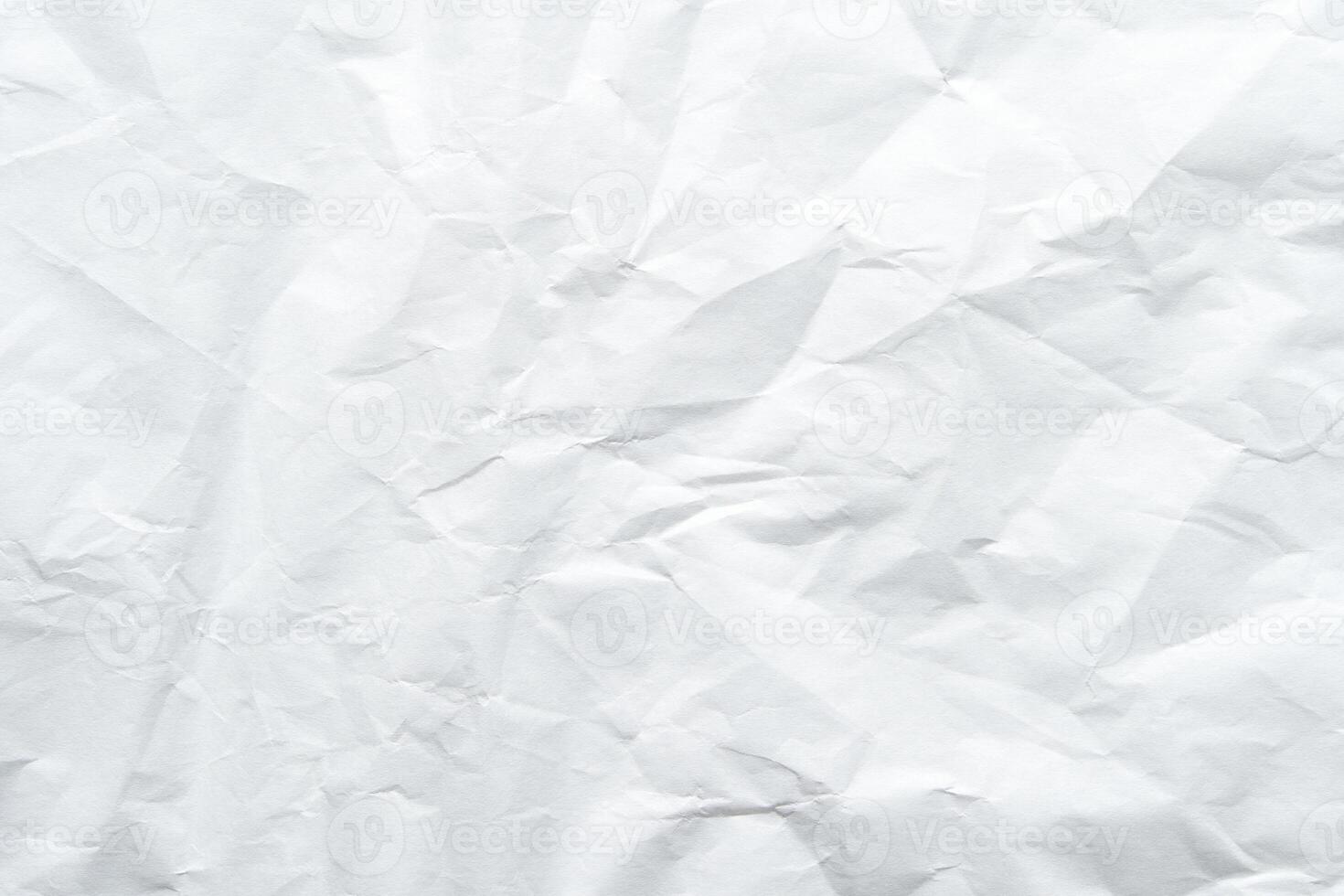 Textured crumpled white paper background with creases and wrinkles. photo