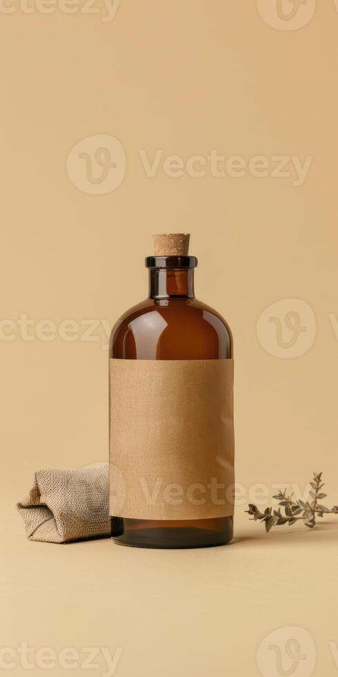 Amber glass bottle on beige background with cork top and brown label in minimalist setting photo