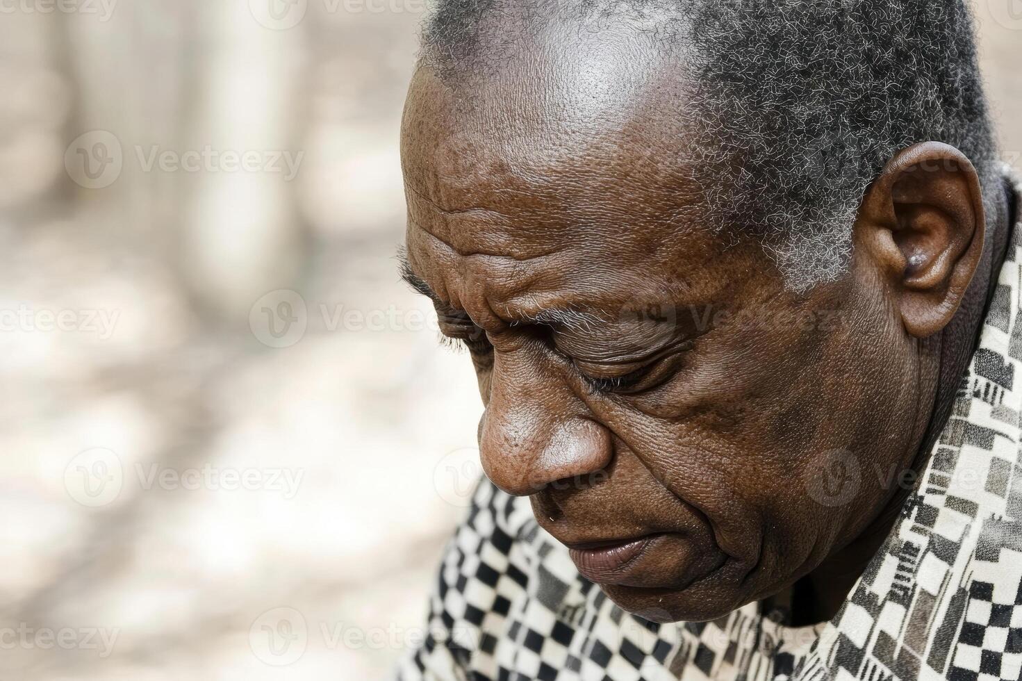 Elderly Man in Thoughtful Reflection Outdoors in Natural Light photo