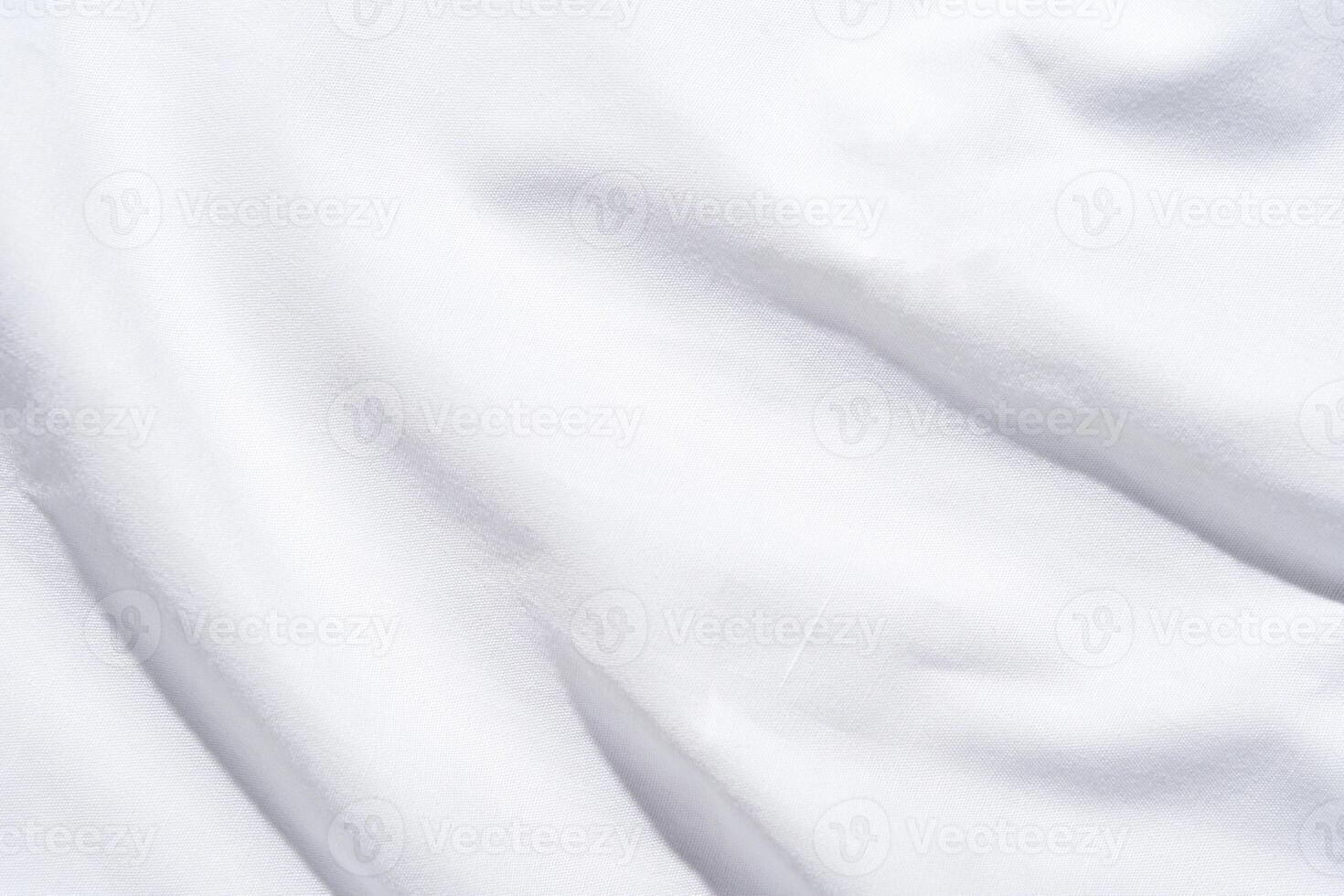 Smooth white fabric texture with soft light and subtle shadows for background or design. photo