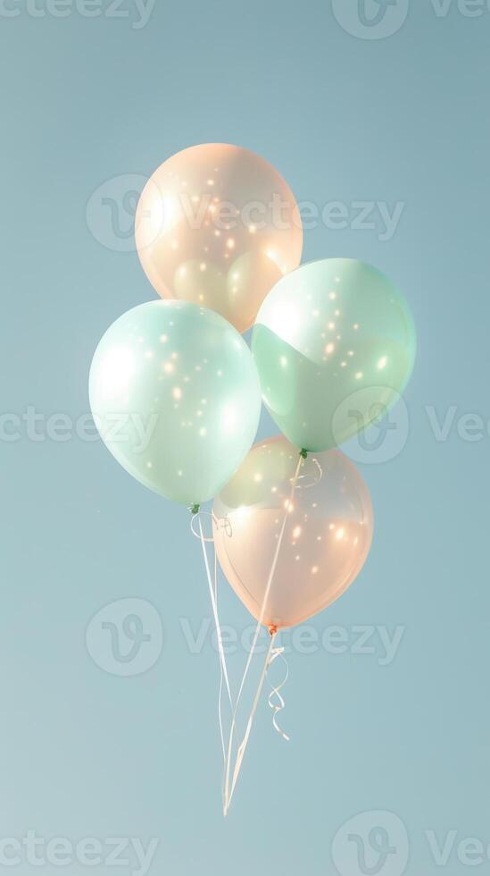 Pastel balloons floating against a clear blue sky photo