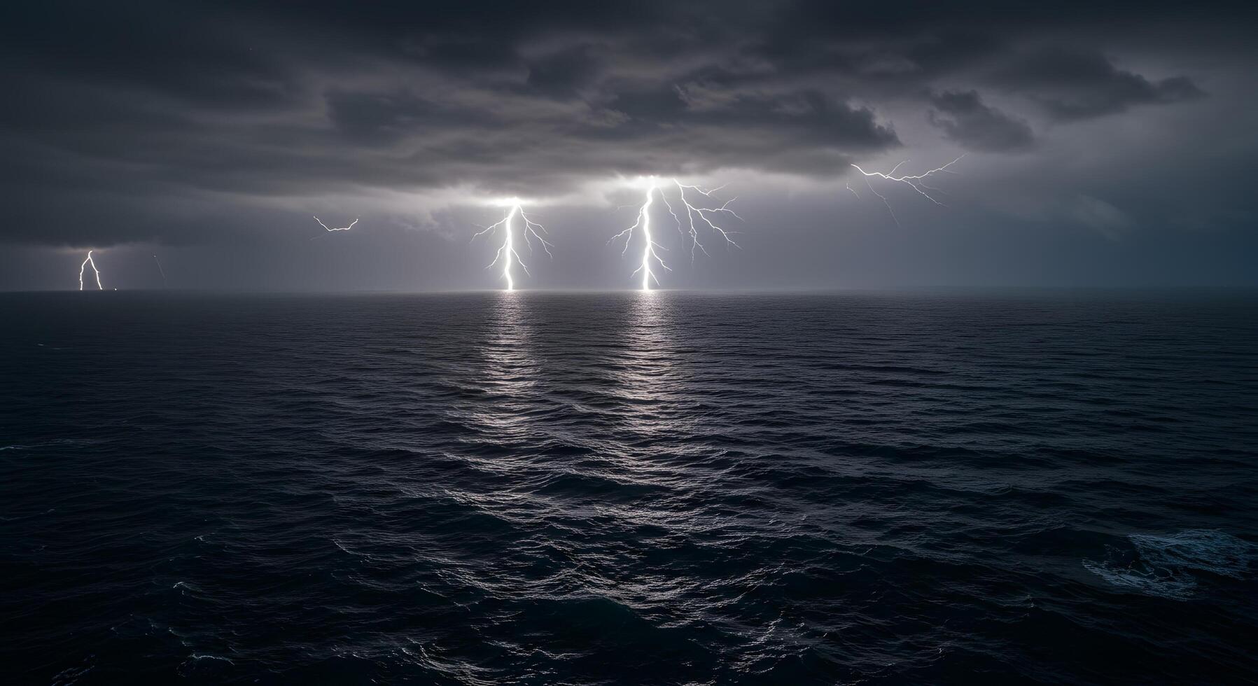 Dramatic Thunderstorm With Multiple Lightning Strikes Over the Dark Ocean photo