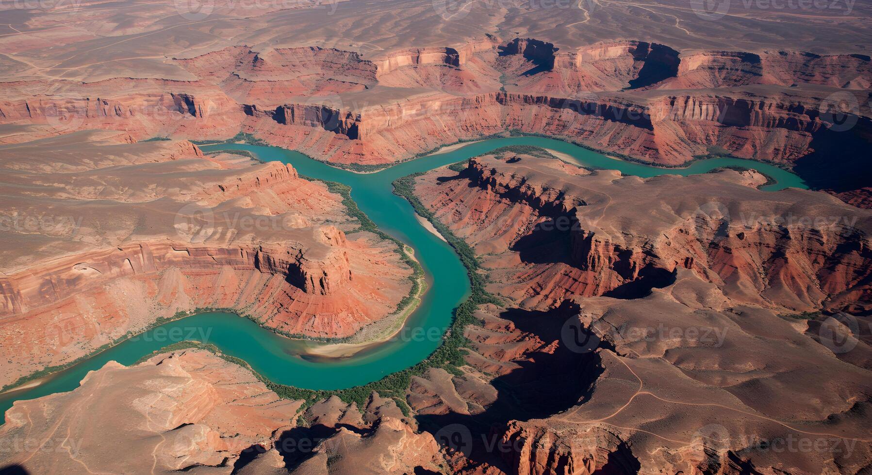 Aerial view of a winding river cutting through a red rock canyon photo