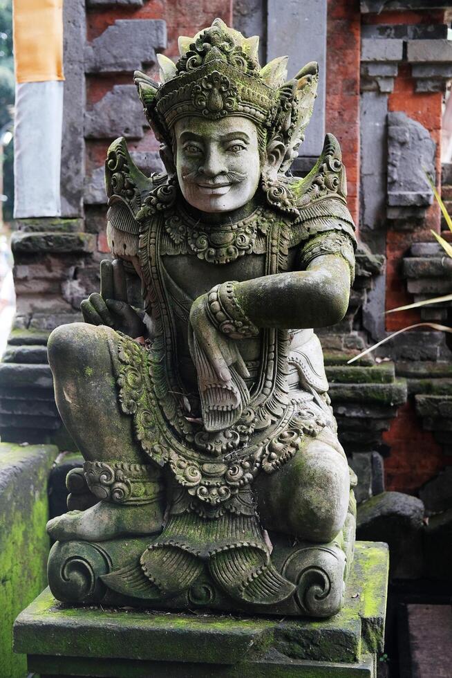 Ancient Hindu god man stucco statue for belief with religion and culture decorated outdoor front arched entrance at the temle in Asian photo