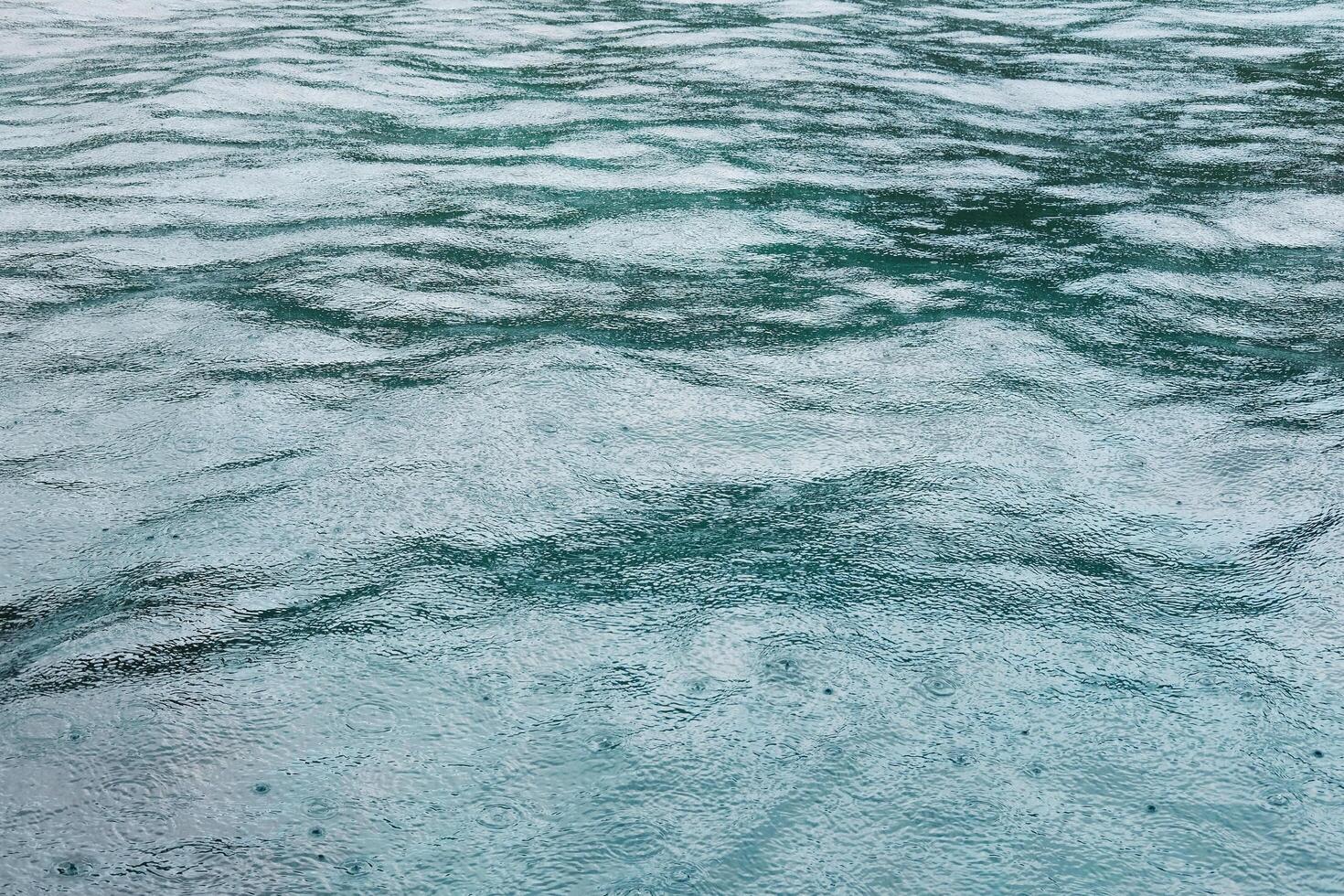 Fresh of the rain falling on the calm sea surface with feeling of relaxation and peace in tropical natural seasonal photo