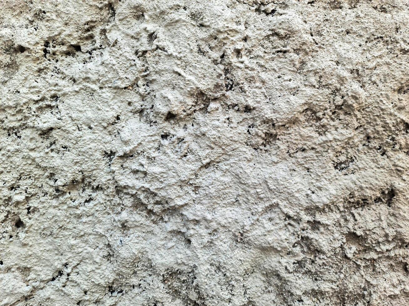 Rough textured white concrete wall creating an abstract background photo