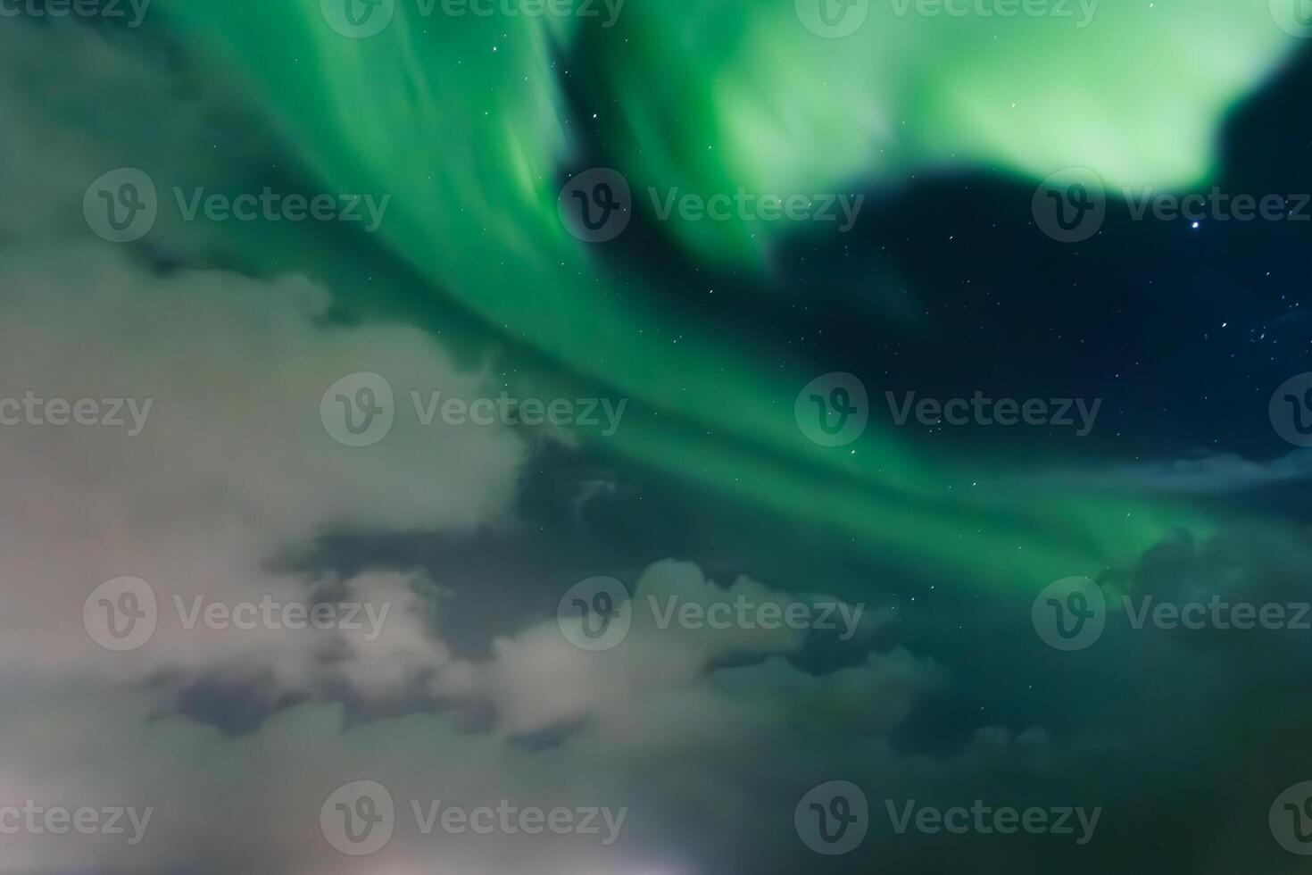 The bright and green aurora borealis illuminating the night sky in iceland photo