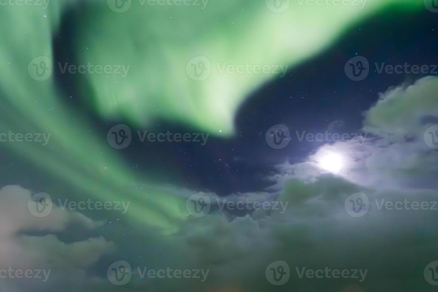 Bright aurora borealis illuminating night sky over iceland photo