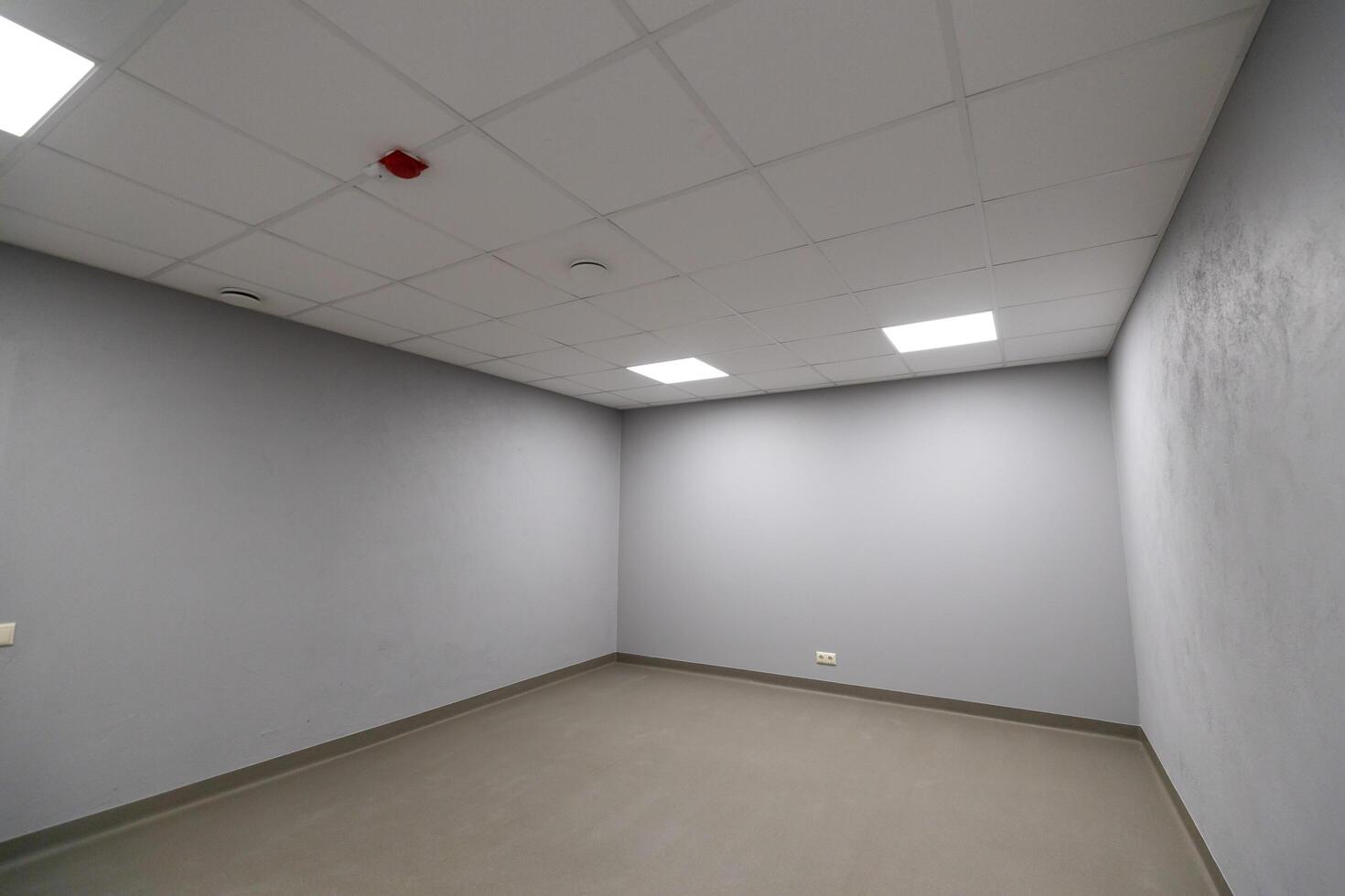 Riga, Latvia, 2024 - Minimalistic Room with Gray Walls and Fluorescent Lighting photo