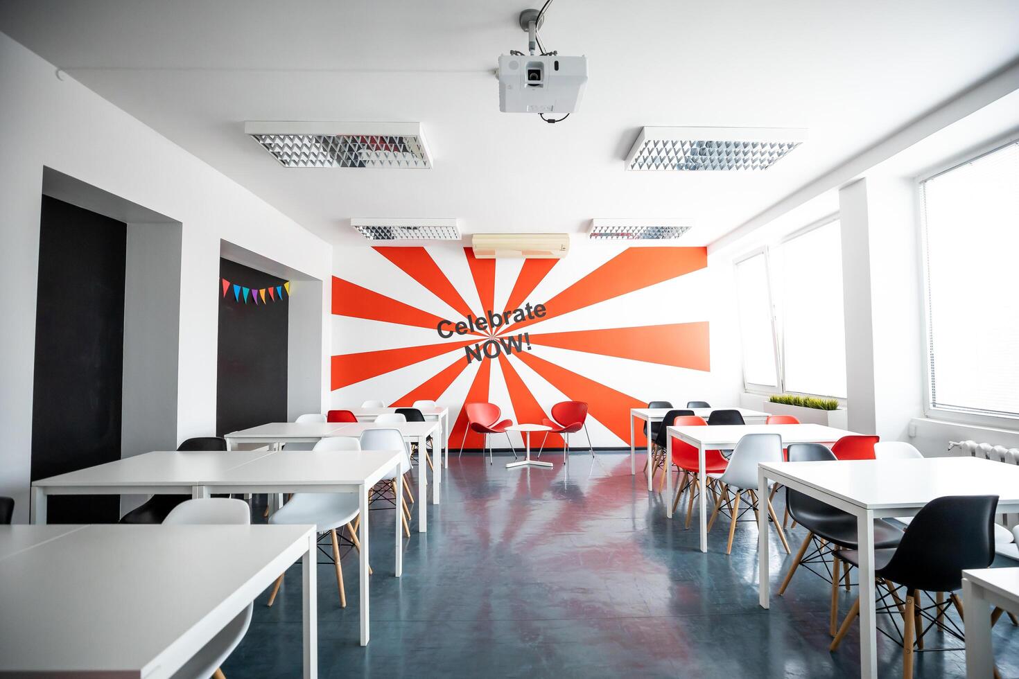 Riga, Latvia, 2024 - Modern Room with Bold Red and White Ray Design and Projector photo