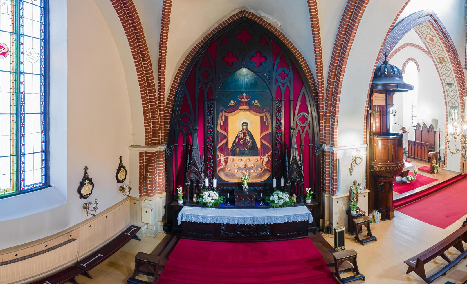 Riga, Latvia, 2024 - Interior of Church with Gothic Arches and Stained Glass Windows photo