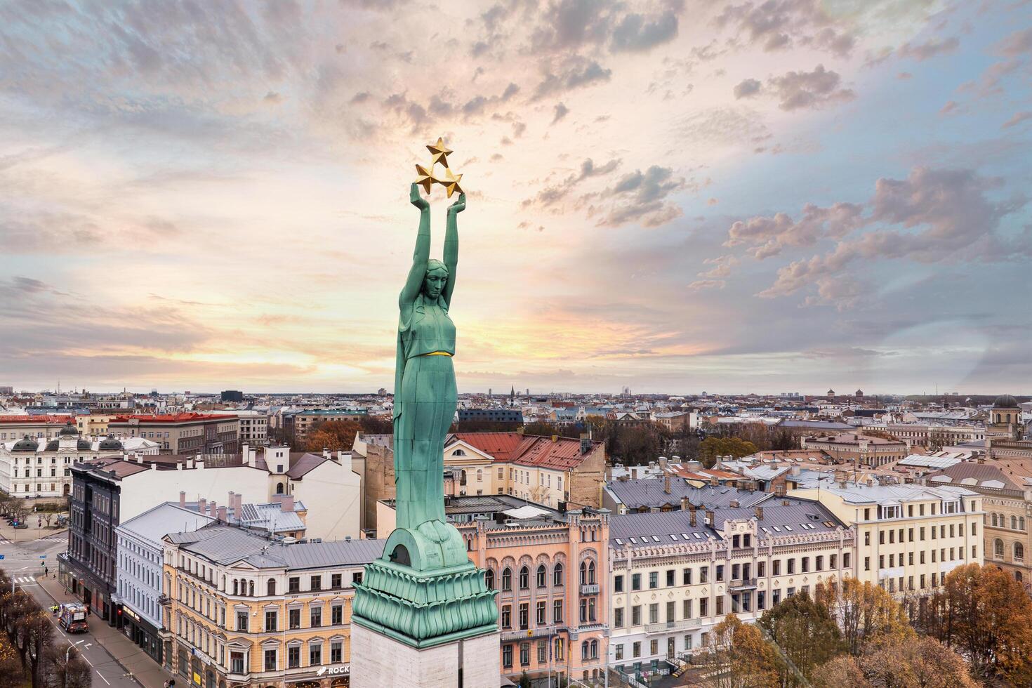 Riga, Latvia, 2024 - Aerial View of Freedom Monument and Riga Cityscape at Sunset photo