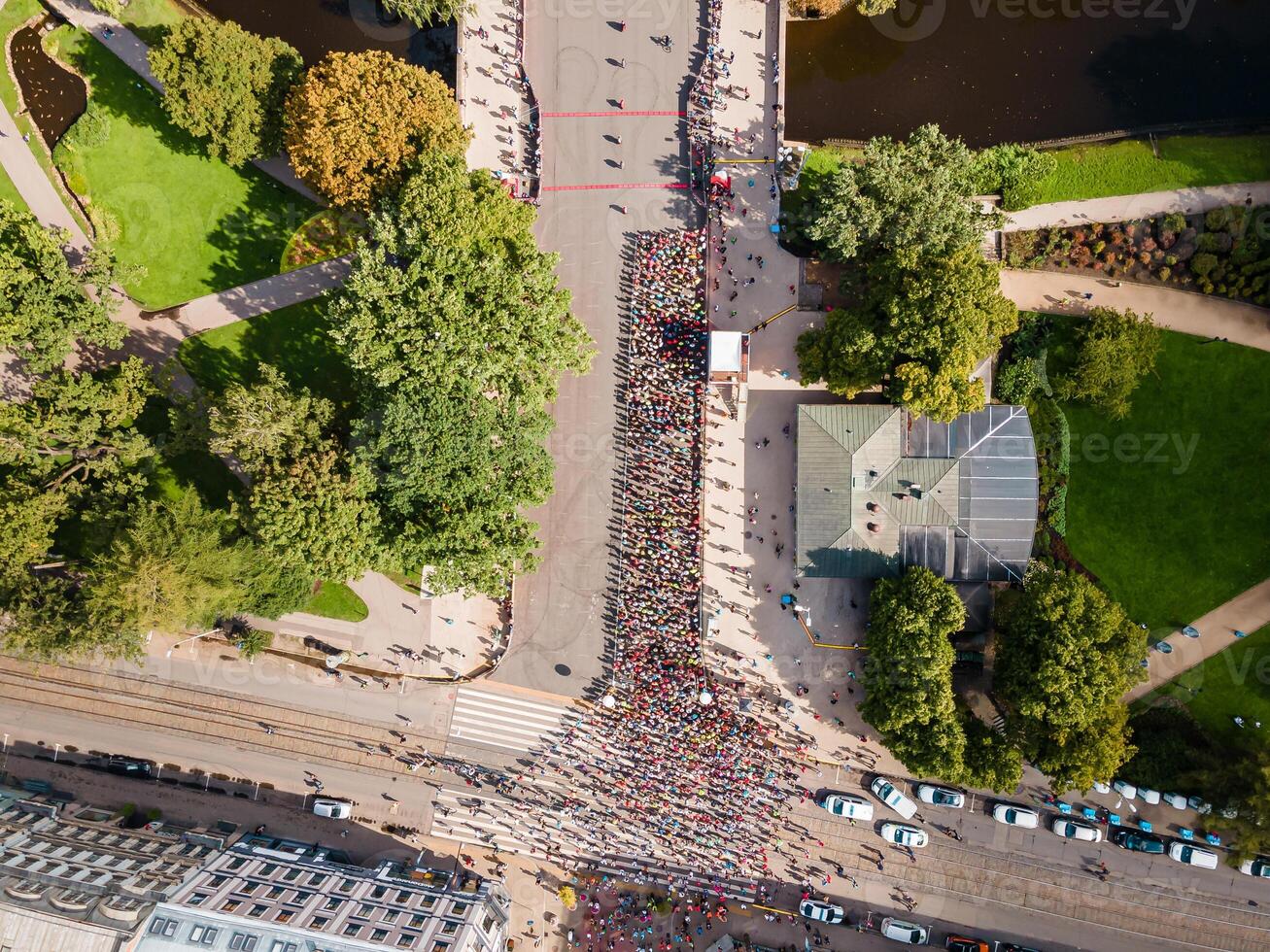 Aerial View of Crowd at Event on Paved Road in Urban Park Setting photo