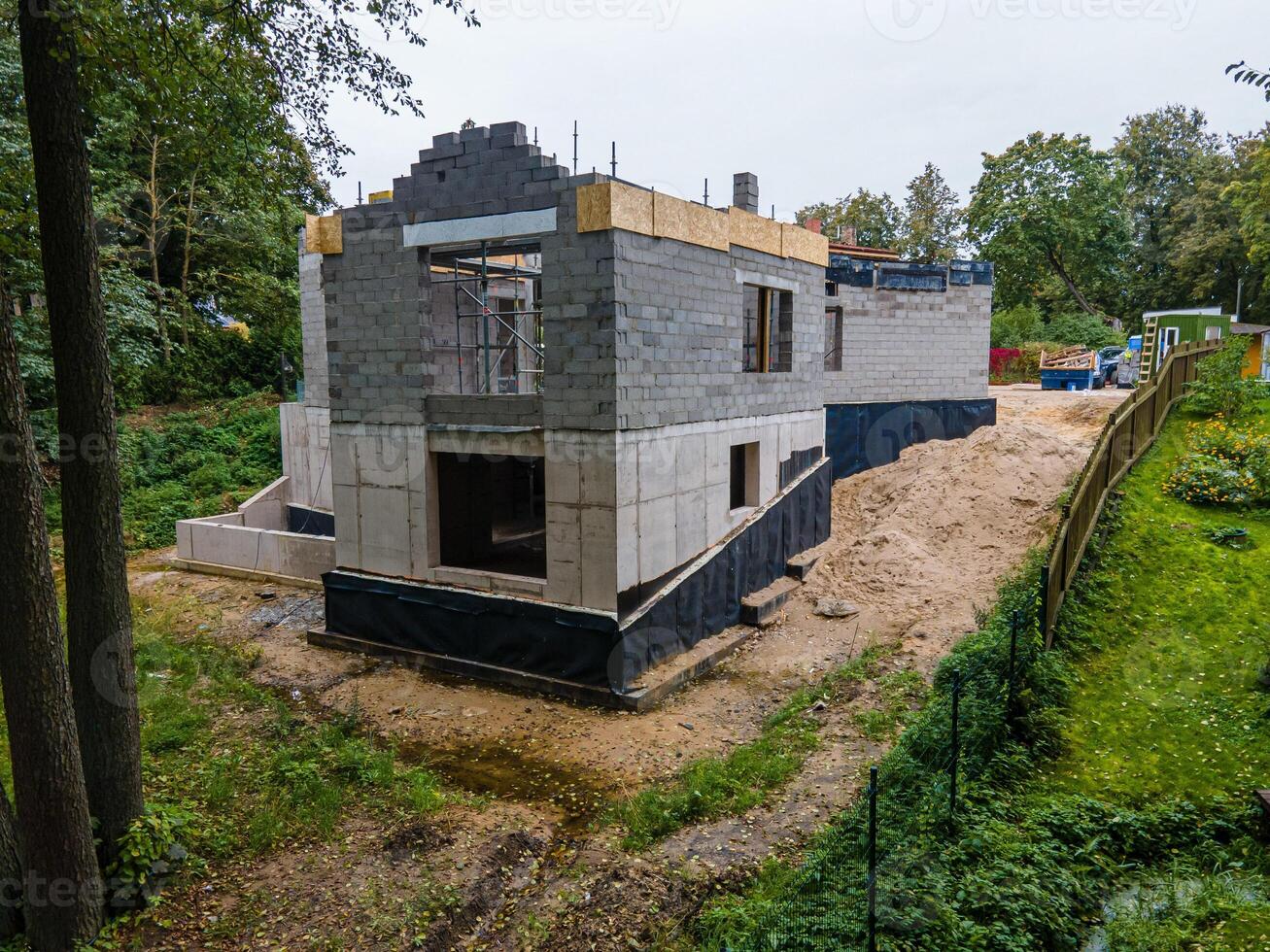 Partially Constructed Two Story Building in a Wooded Area photo