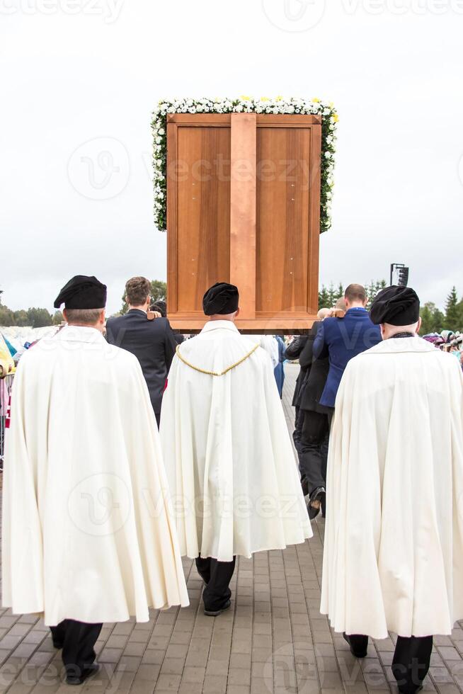 Ceremonial Procession with Wooden Structure and Floral Decorations photo