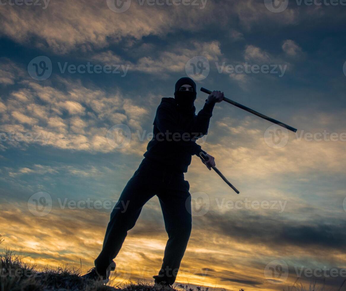 Training with poles at sunset photo