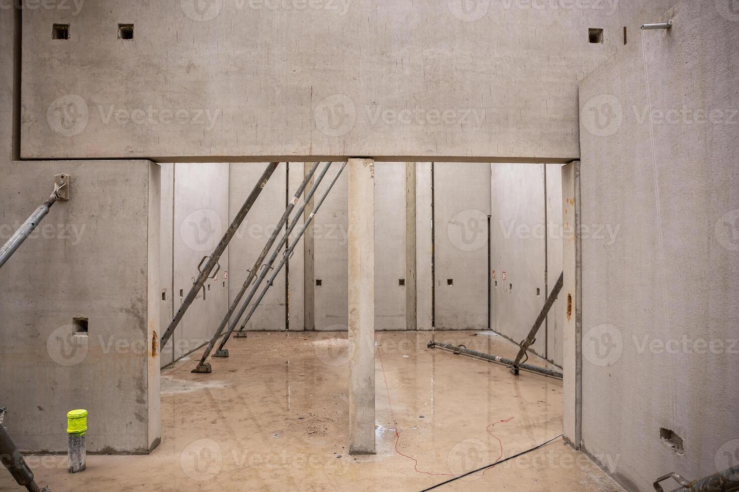 Interior of Construction Site with Concrete Walls and Metal Beams photo