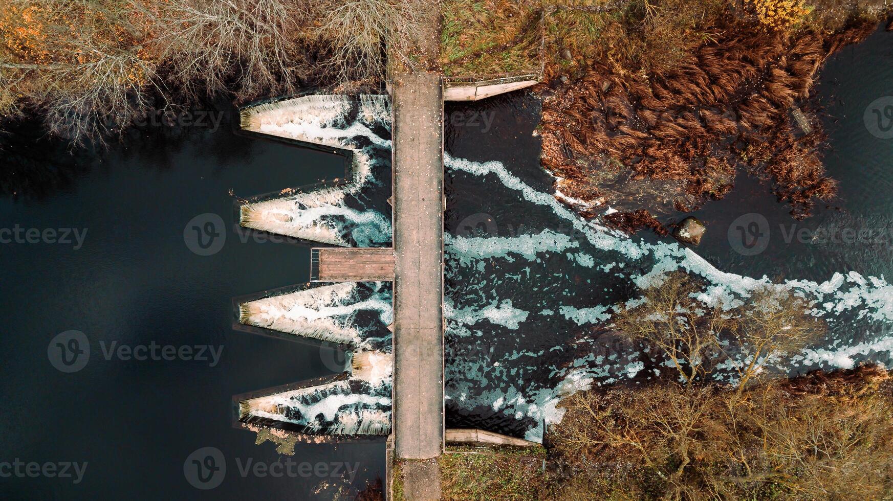 Aerial View of Dam with Triangular Openings and Pedestrian Bridge photo