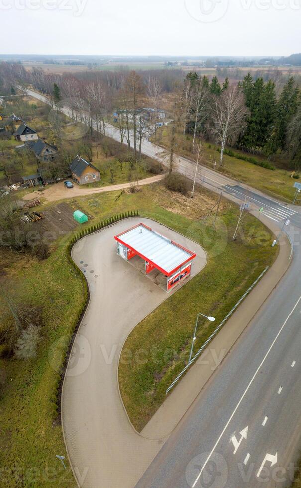 Aerial View of Gas Station with Red and White Roof in Rural Area photo