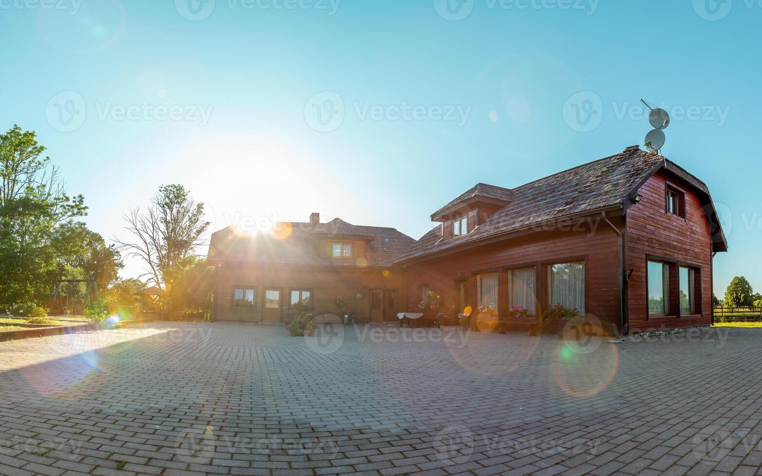 Rustic Wooden House with Gabled Roofs in a Rural Setting photo