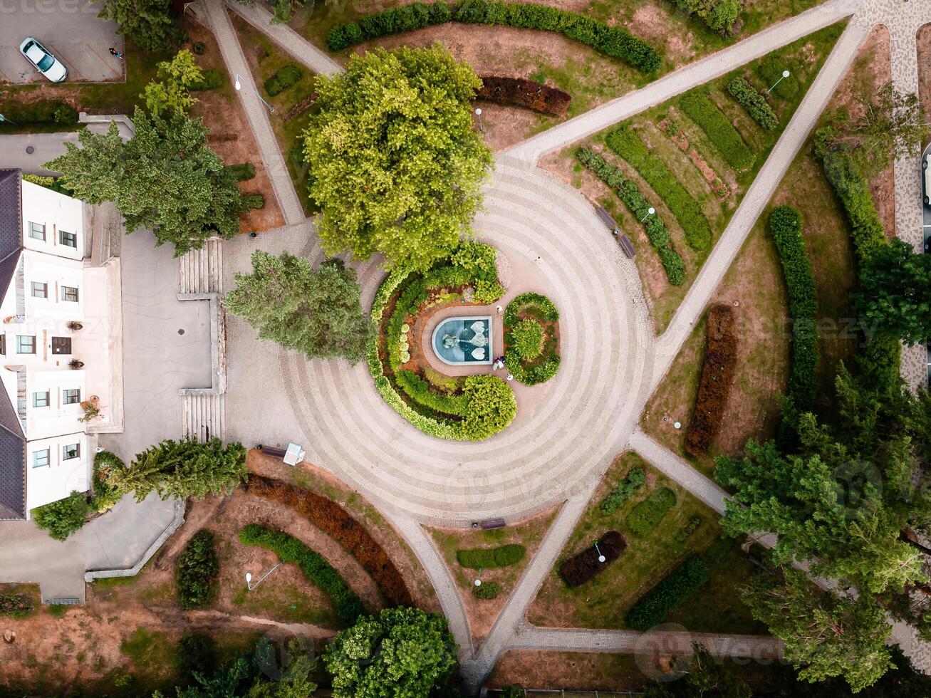 Aerial View of Symmetrical Garden with Circular Fountain and Pathways photo